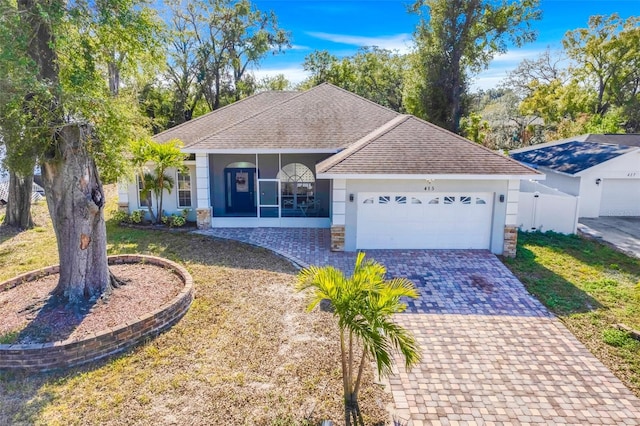 ranch-style house featuring a front lawn and a garage