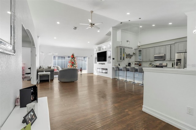 living room with ceiling fan, dark hardwood / wood-style flooring, and high vaulted ceiling