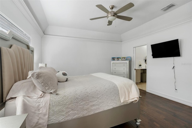 bedroom featuring ceiling fan, dark hardwood / wood-style flooring, and connected bathroom