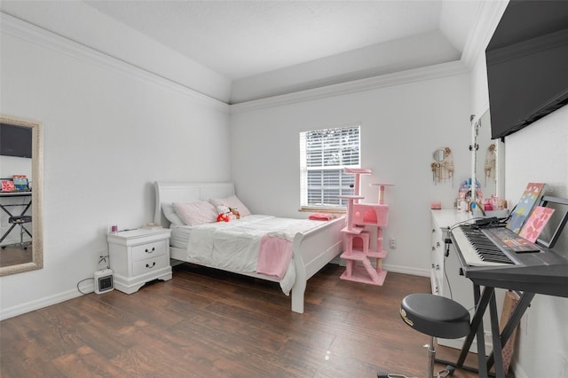 bedroom with a raised ceiling, dark hardwood / wood-style floors, and ornamental molding