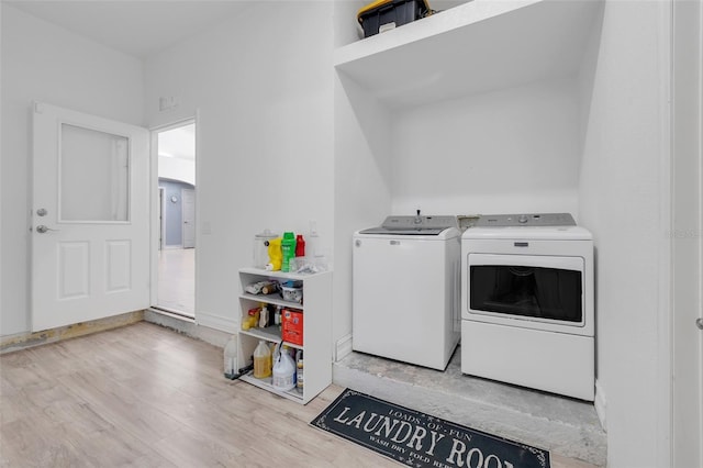 washroom featuring light hardwood / wood-style flooring and washing machine and dryer