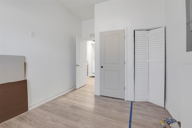 unfurnished bedroom featuring a closet and light hardwood / wood-style flooring