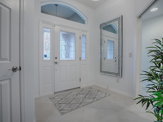 foyer entrance featuring light tile patterned flooring