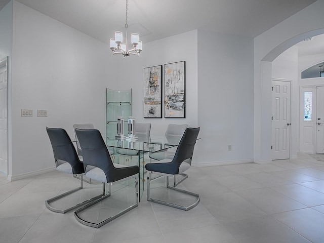 dining room featuring light tile patterned flooring and a chandelier