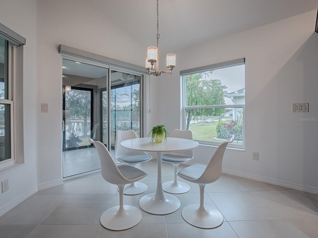 dining room featuring an inviting chandelier, light tile patterned flooring, and lofted ceiling