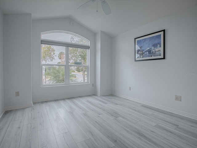 unfurnished room featuring ceiling fan, light wood-type flooring, and vaulted ceiling