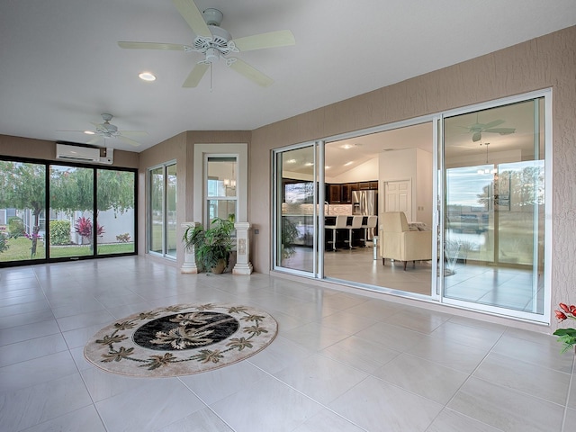 interior space featuring a wall unit AC and ceiling fan