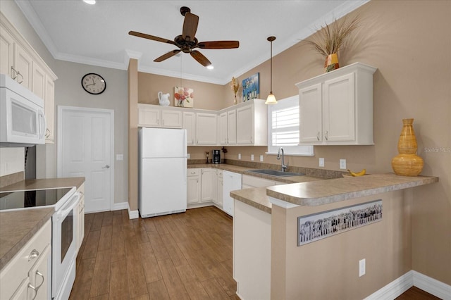 kitchen featuring white appliances, white cabinetry, sink, kitchen peninsula, and ornamental molding