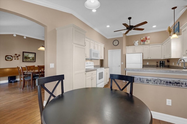 kitchen with white cabinetry, white appliances, and crown molding