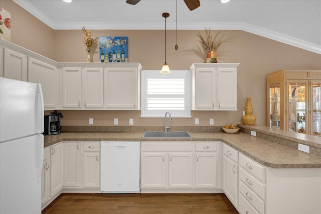 kitchen with pendant lighting, white appliances, sink, ornamental molding, and kitchen peninsula