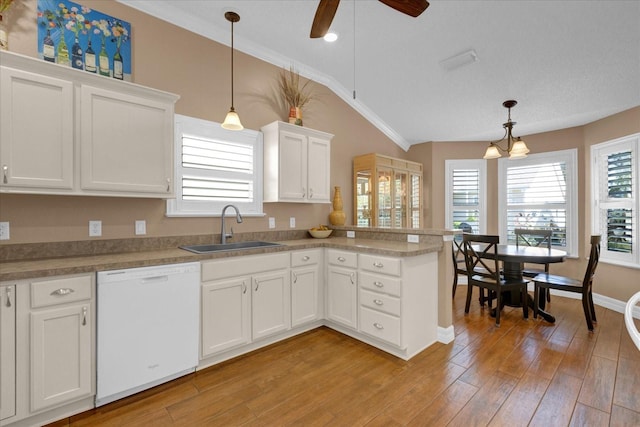 kitchen featuring dishwasher, hanging light fixtures, crown molding, white cabinets, and sink