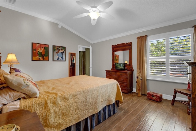 bedroom featuring ceiling fan, vaulted ceiling, ornamental molding, and hardwood / wood-style floors