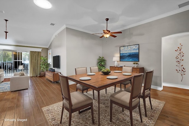 dining space featuring hardwood / wood-style flooring, ornamental molding, and ceiling fan