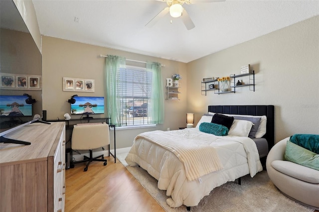 bedroom with ceiling fan and light wood-type flooring