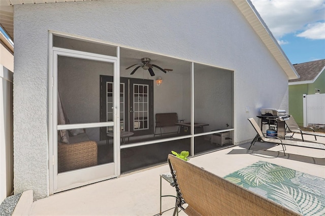 rear view of property featuring a patio, a sunroom, and ceiling fan