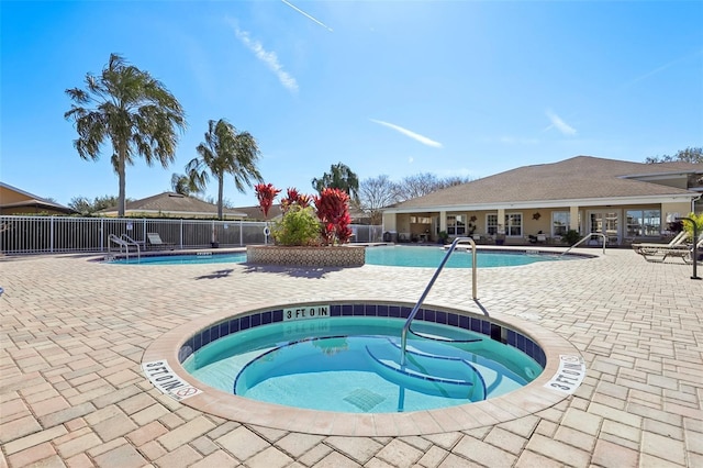 view of pool with a hot tub and a patio area