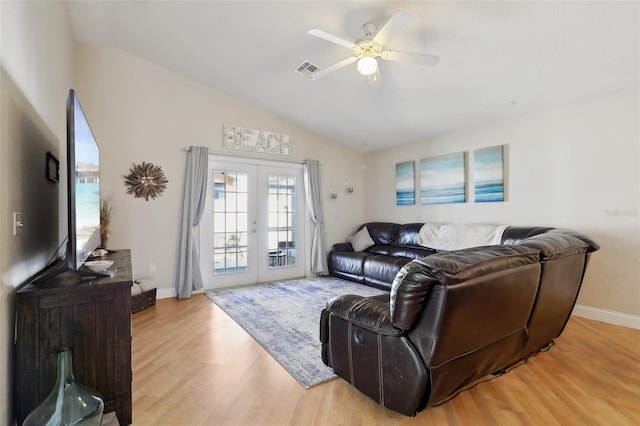 living room with french doors, ceiling fan, lofted ceiling, and light wood-type flooring