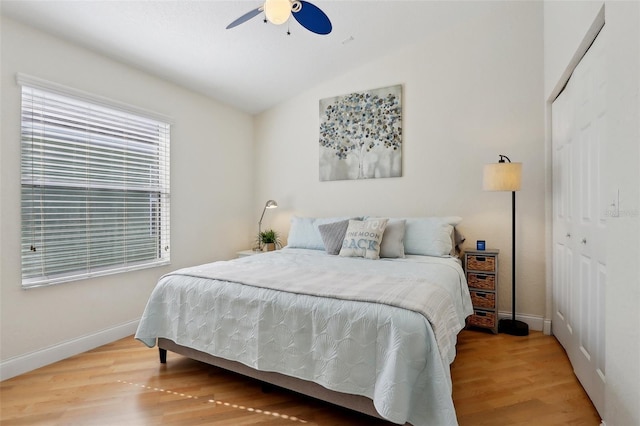 bedroom featuring lofted ceiling, hardwood / wood-style floors, ceiling fan, and a closet