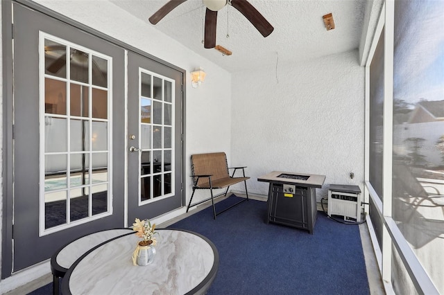 sunroom featuring ceiling fan and french doors