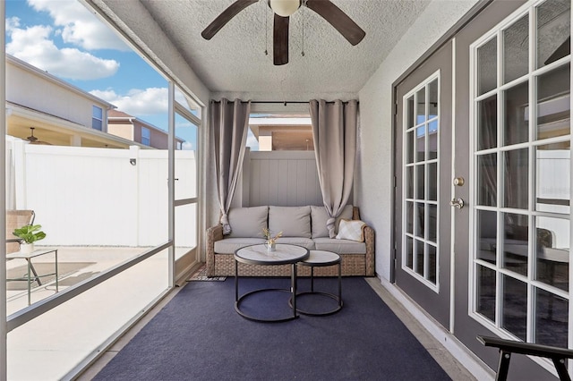 sunroom featuring ceiling fan