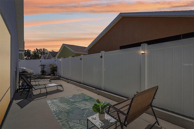 view of patio terrace at dusk