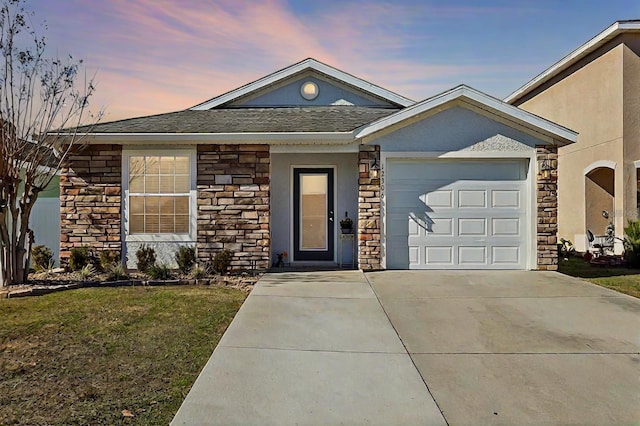 ranch-style house featuring a garage and a lawn