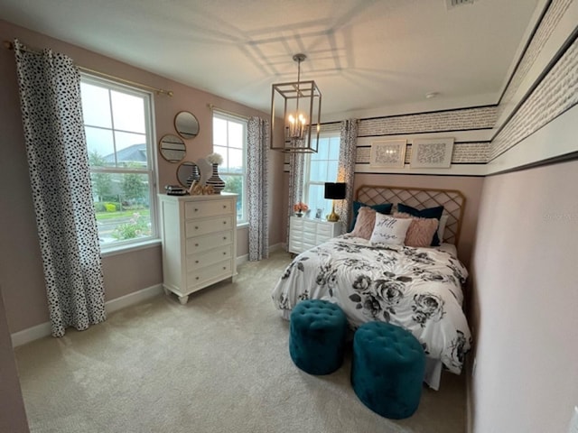 carpeted bedroom with a chandelier and multiple windows