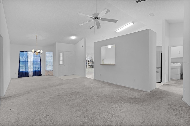 unfurnished living room with lofted ceiling, washer / dryer, light carpet, and ceiling fan with notable chandelier