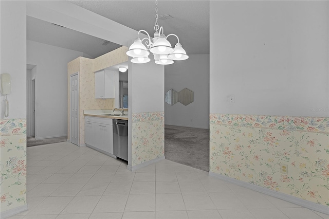 kitchen with pendant lighting, sink, dishwasher, white cabinets, and light colored carpet