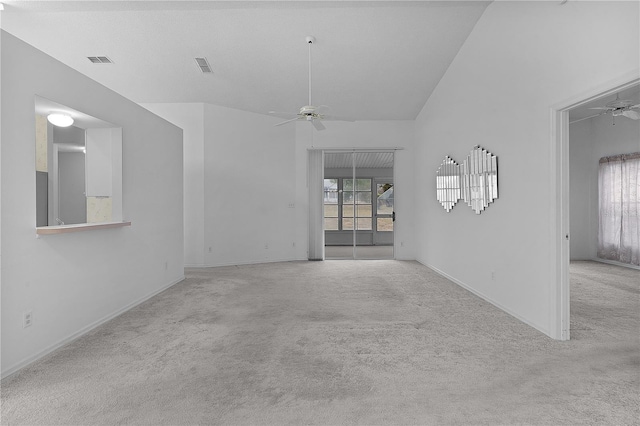 unfurnished room featuring light carpet, high vaulted ceiling, and ceiling fan