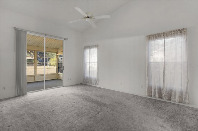 carpeted spare room with high vaulted ceiling and ceiling fan