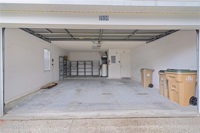 garage with a garage door opener, electric panel, and water heater