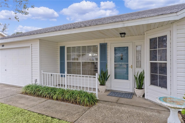 view of exterior entry with a garage