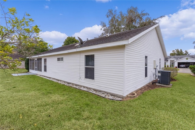 view of property exterior with a lawn and central air condition unit