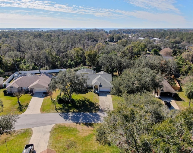 birds eye view of property with a wooded view