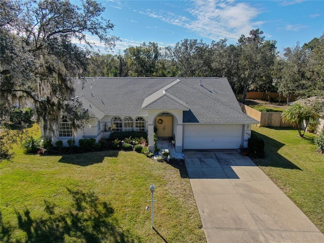 view of front of home with a garage, fence, concrete driveway, and a front yard