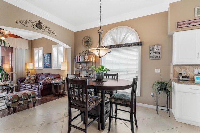 dining space with light tile patterned floors and ceiling fan