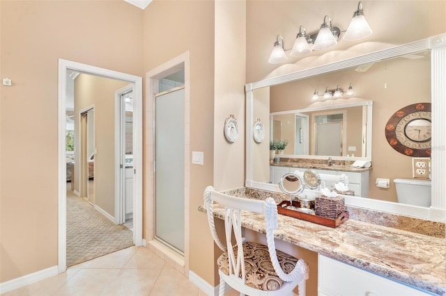 bathroom featuring tile patterned floors, an enclosed shower, and vanity