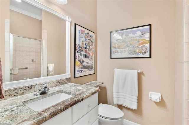 bathroom with ornamental molding, vanity, toilet, and a shower with shower door