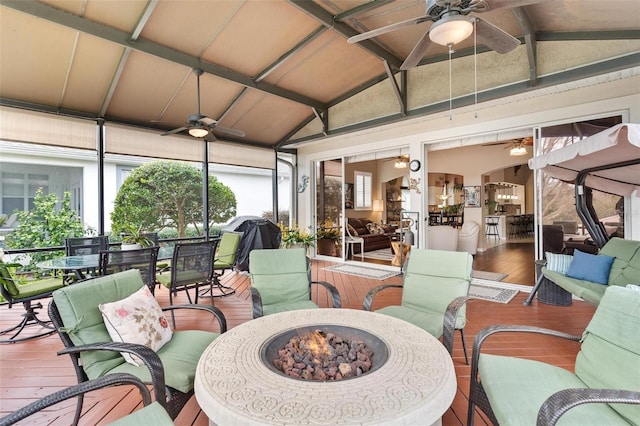 sunroom / solarium with lofted ceiling and ceiling fan