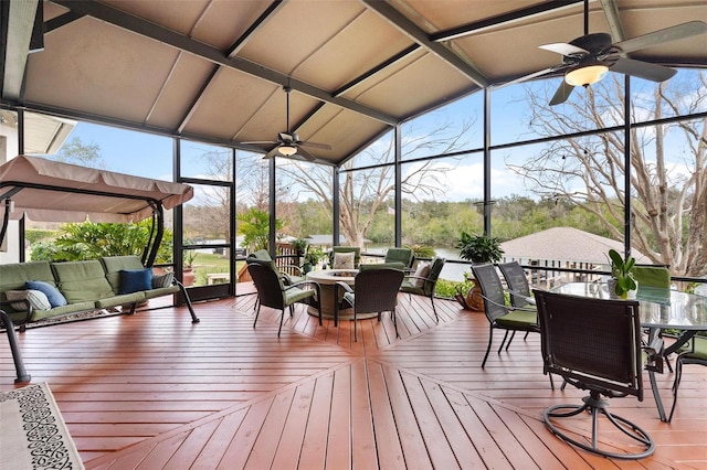 sunroom / solarium featuring ceiling fan