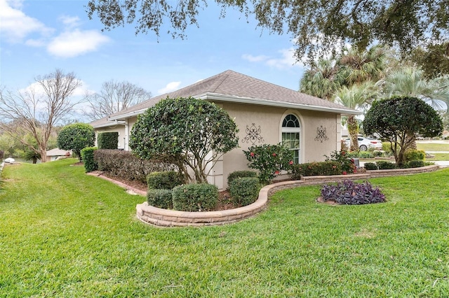 view of side of home with a lawn