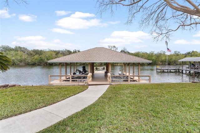 view of dock featuring a lawn and a water view