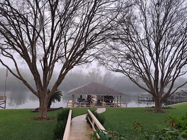 view of home's community with a gazebo, a lawn, and a water view