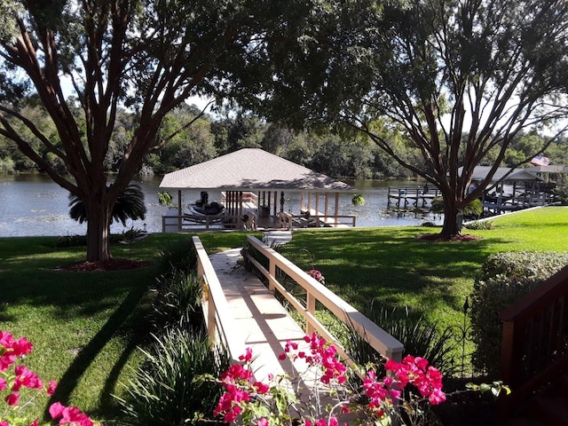 view of home's community with a yard and a water view