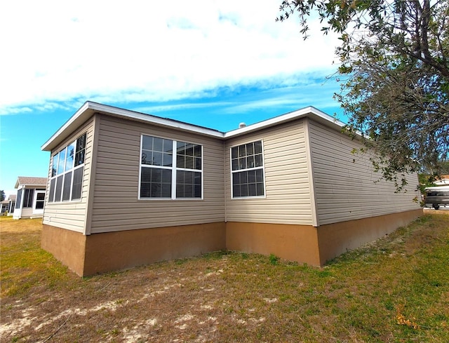 view of home's exterior with a yard