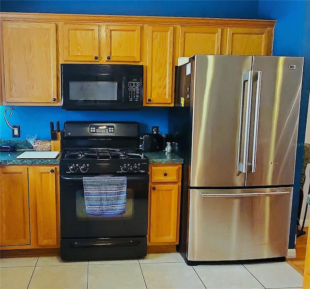 kitchen with black appliances and light tile patterned flooring