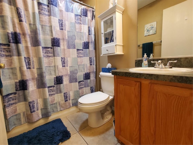 bathroom with vanity, toilet, and tile patterned flooring