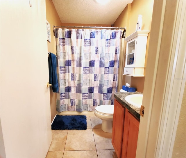 bathroom with tile patterned floors, toilet, vanity, and a textured ceiling