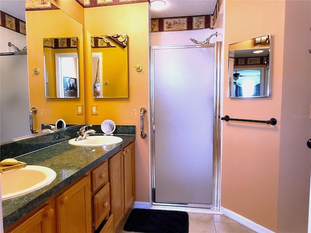 bathroom with vanity, a shower with shower door, and tile patterned flooring